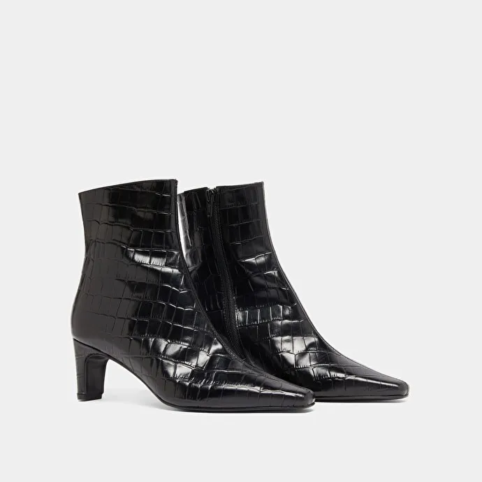 Pointed-toe ankle boots in black reptile leather